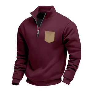 Detail of men's burgundy fleece sweatshirt with stand collar and tan chest pocket