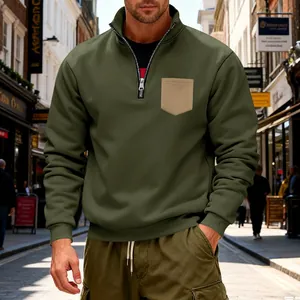 Close-up of olive green quarter-zip sweatshirt showing fabric texture and chest pocket