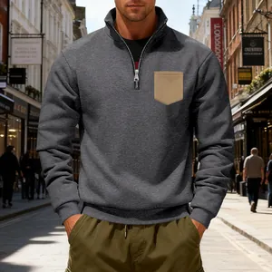 Detail view of men's grey heavy fleece quarter-zip sweatshirt with chest pocket.