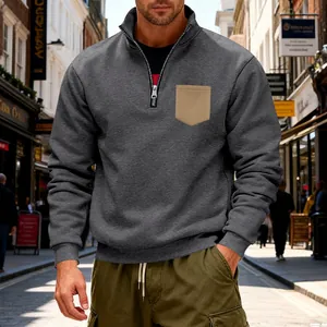 Close-up of men's quarter-zip fleece sweatshirt with contrast pocket and stand collar
