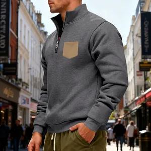 Detail of grey heavy fleece half-zip sweatshirt with contrasting khaki chest pocket