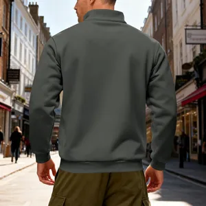 Back view of a heavyweight grey stand-collar sweatshirt on a man in a street