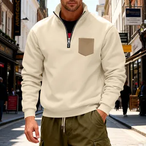 Close-up detail of a men's heavyweight beige half-zip sweatshirt with chest pocket
