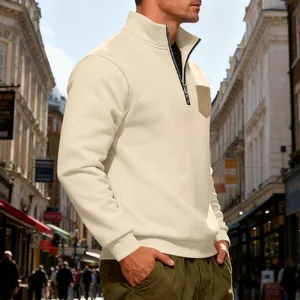 Detail view of men's cream heavyweight half-zip fleece sweatshirt in city setting