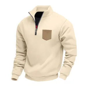 Close-up of men's beige half-zip sweatshirt with a contrasting brown chest pocket.