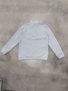 Back view of a heavy grey half-zip sweatshirt with a stand collar and ribbed cuffs.