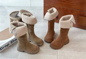 Detail of children's warm winter boots with thick shearling lining and stylish turnover.