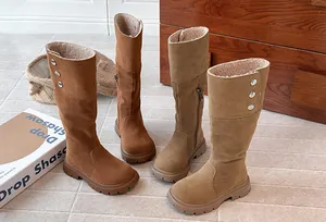 Detailed view of girls' warm fleece-lined tall winter boots in brown and tan shades