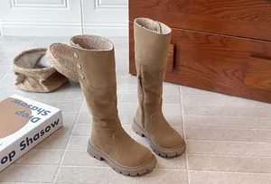 Detailed view of girls' warm fleece-lined tall boots in Maillard brown suede.