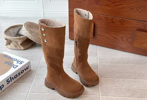 Detail view of brown suede girls' tall boots with warm fleece lining and button accents
