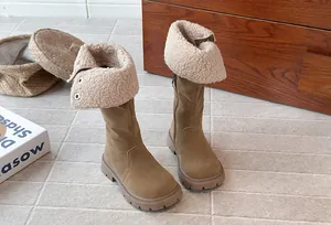 Detail view of girls' brown fleece-lined high boots with warm shearling cuff