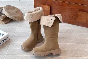 Detail of warm fleece-lined brown high boots for girls with stylish fold-over cuff