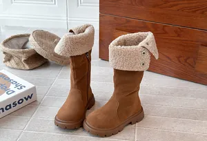 Detailed view of children's brown winter boots with warm sherpa lining and snaps