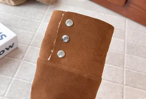 Detail view of girls' brown suede high boots featuring silver snap buttons and warm lining