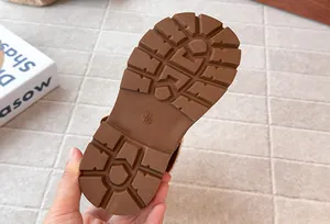 Close-up macro detail of non-slip rubber sole for girls Maillard brown tall winter boots