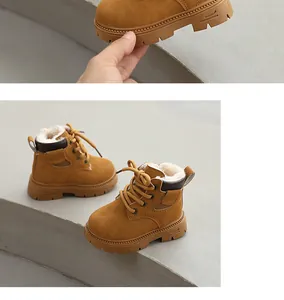 Detailed macro view of warm yellow children's Martin boots with thick white fleece lining.