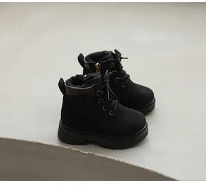 Classic black children's Martin boots featuring warm faux fur lining and side zipper