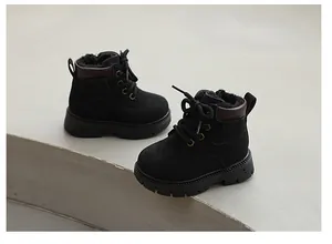 Detailed view of children's black Martin boots with warm winter fleece lining and soft soles