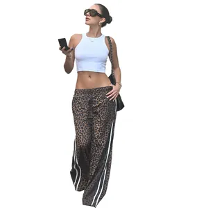 Full-length view of stylish leopard print wide-leg pants with side stripes on fashion model