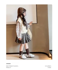 Young girl model wearing white athletic German trainers with preppy school-style outfit