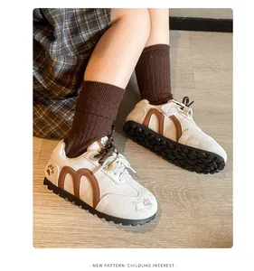 Detailed view of girls' retro sneakers with cute animal embroidery and M pattern