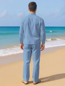Rear view of a men's light blue linen shirt and pants suit on a scenic sunny beach