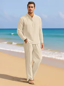 High-quality detail of men's beige linen summer shirt and trousers set on a beach