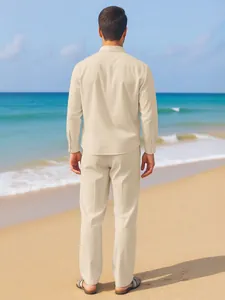 Detailed back view of a men's beige linen shirt and trousers set on a sunny beach