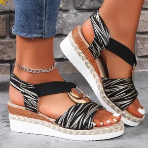 Stylish Roman-style zebra print wedge sandals with woven platform and metal buckle.