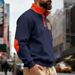 Detail of men's navy quarter-zip fleece sweatshirt with orange collar and elbow patches.