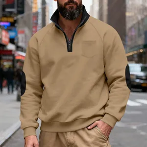 Detail view of khaki quarter-zip sweatshirt with black elbow patches and stand collar