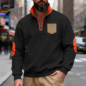 Detailed view of men's black fleece sweatshirt with orange collar and elbow patches
