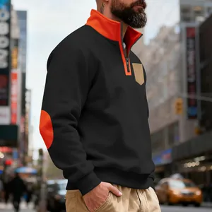 Close-up of men's black fleece quarter-zip sweatshirt with orange elbow patches