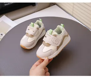 Close-up of stylish toddler girls' walking shoes with cartoon pig and Velcro