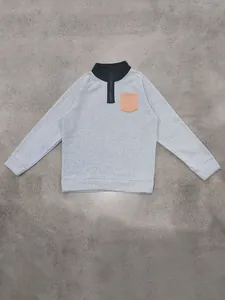 Detail view of men's grey fleece sweatshirt with black half-zip collar and tan pocket