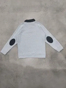 Back view of a grey stand-up collar sweatshirt featuring black elbow patches and fleece