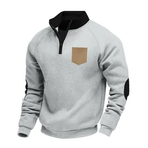 Men's grey half-zip fleece sweatshirt featuring a contrast collar and chest pocket