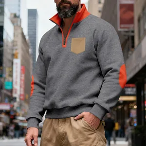 Detail of men's heavy fleece half-zip sweatshirt with orange elbow patches