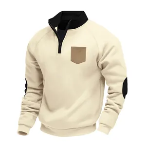 Detail of men's heavyweight fleece quarter-zip sweatshirt in cream with contrast pocket.