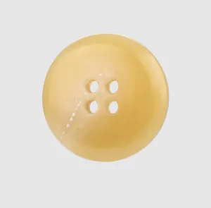 Detailed macro view of a pale yellow four-hole urea button with marble texture.