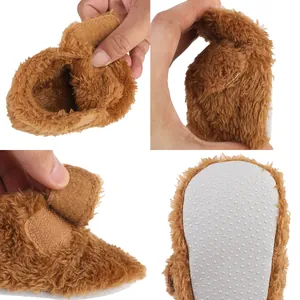 Detail of soft brown plush baby pre-walker shoes showing anti-slip sole texture