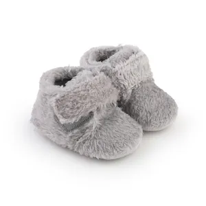 Close-up detail of grey fuzzy baby walker shoes with soft faux fur texture