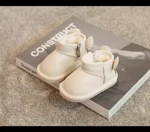 Cream toddler winter snow boots with plush lining and cute ear details for warmth