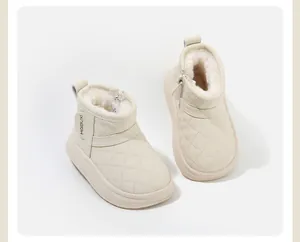 Macro detail view of cream quilted toddler winter boots featuring warm faux-fur lining