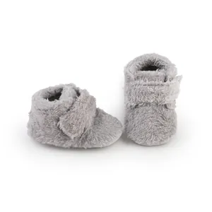 Detailed view of grey fuzzy plush baby pre-walker shoes with Velcro closure