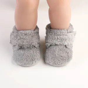Close-up front view of grey fuzzy baby walking shoes with soft faux fur texture