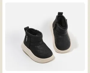 Close-up detail of children's black quilted winter boots with thick sole and fur lining.