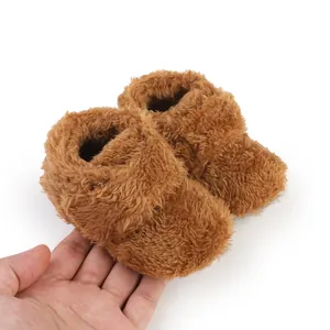 Close-up of soft brown fluffy baby walking shoes for infants aged 0 to 1 years old.