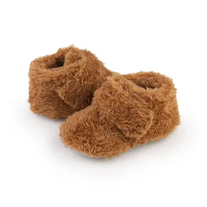 Close-up of brown fuzzy baby booties with soft plush material for warmth
