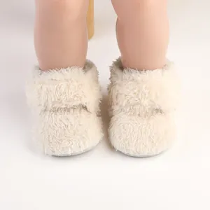 Close-up detail of cream fluffy plush baby toddler walker boots with soft texture